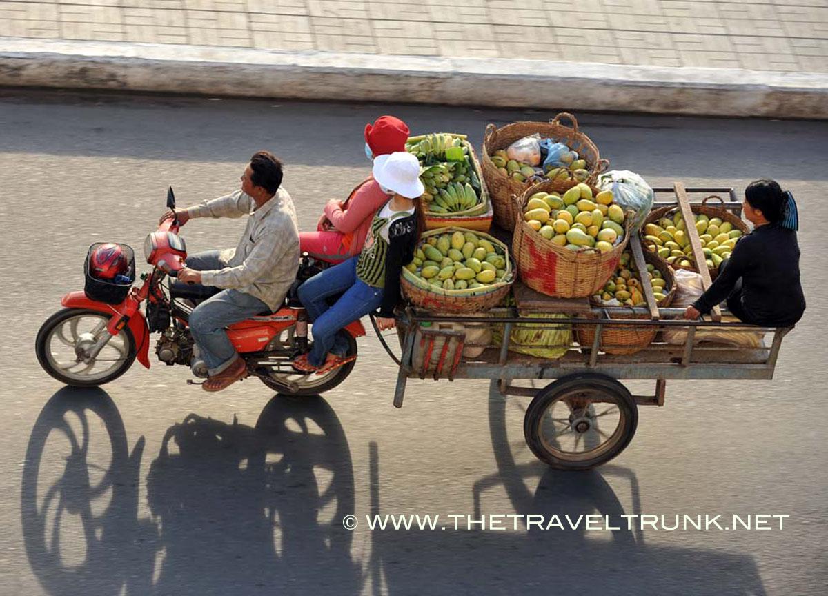 Fruit and the family transport Cambodian style.