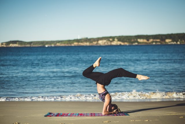 Doing yoga on the beach