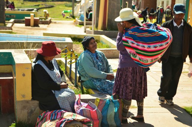 Women selling their textiles on the main harbor at Amantani