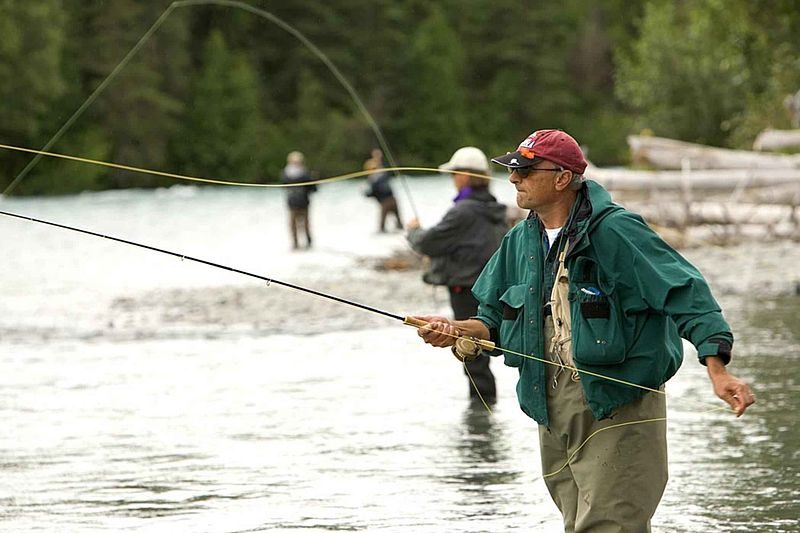 Fly fishermen using chest waders to stay dry