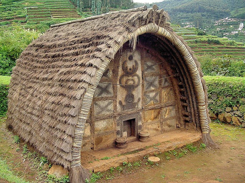 The hut of a Toda Tribe of Nilgiris, India. Note the decoration of the front wall, and the very small door – Author: Pratheep P S – CC BY-SA 3.0