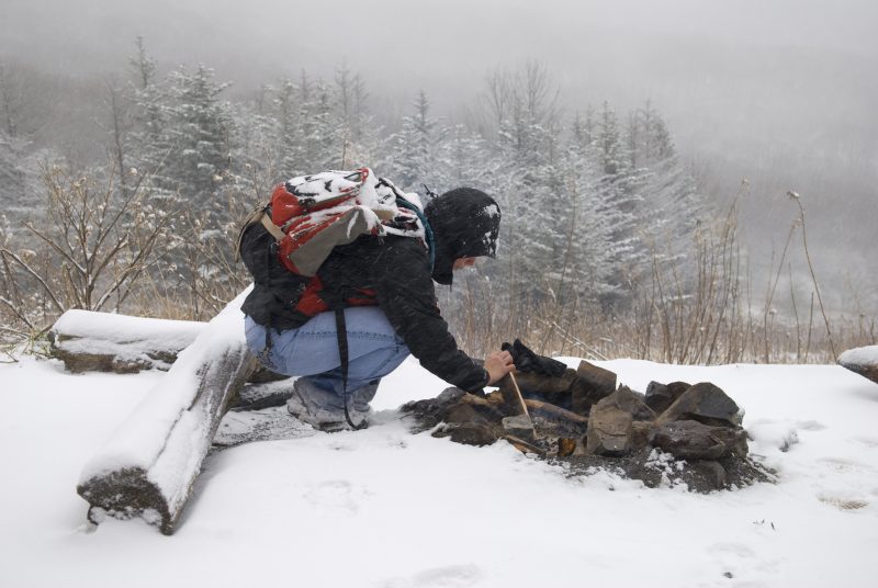 A hiker can start a fire in falling snow with a hand drill.