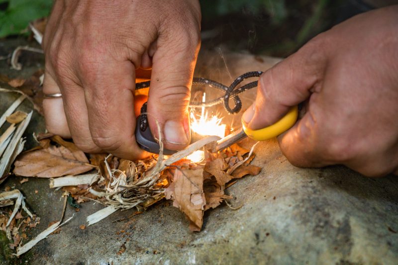 The best position I have discovered is to grip the handle of the firesteel really tight, aim the edge down at dry tinder and then move the striker firmly but slowly over the firesteel and watch as the sparks go on the dry tinder.