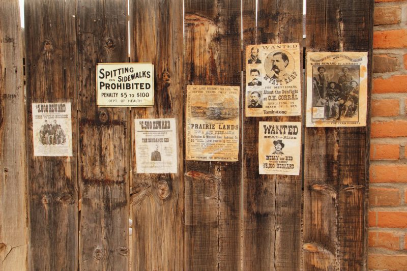 Tucson, Arizona, United States  – November 21, 2014: A number of vintage wanted posters of outlaws including Wyatt Earp, Sundance, the Kid, The James Gang, and The Wild Bunch.