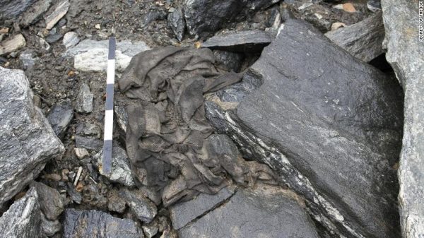 Tunic as found: The tunic as it was found, crumpled up and lying in a depression in the scree. Radiocarbon-dated to c. AD 300. Scale is 50 cm. Photo: secretsoftheice.com.