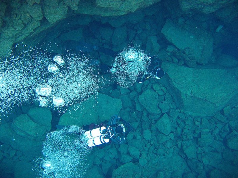 Divers study the fissure at Silfra in Iceland