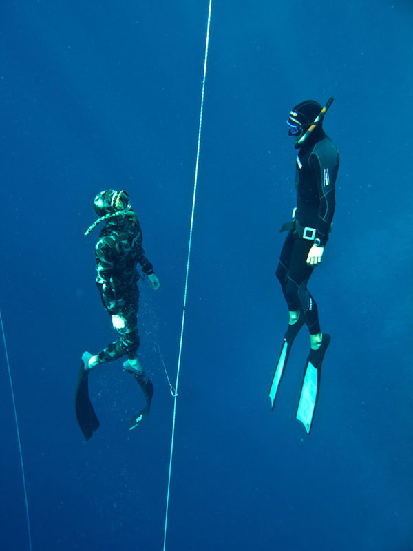 Two divers swimming together