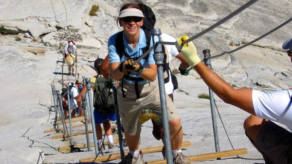 Hikers use steel cables to make their way up the Half Dome 