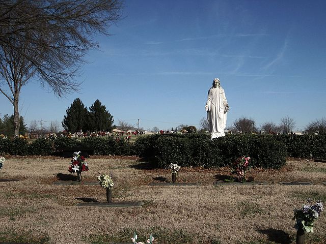 Statue of Jesus standing over cemetery plots at Hendersonville Memory Gardens