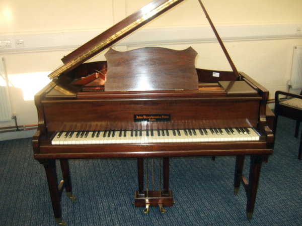 Baby Grand Piano in a carpeted room