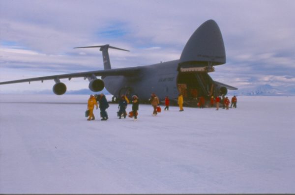 People exiting from the front of an airplane