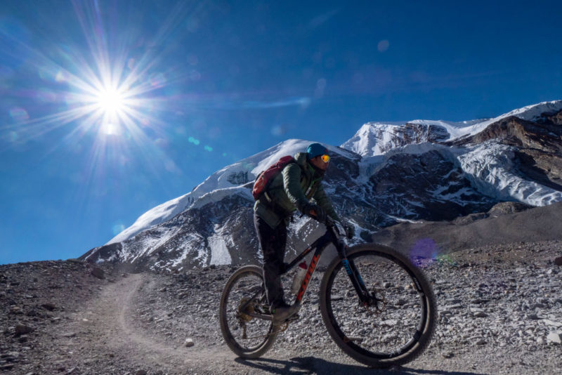 Cyclist riding along a mountainous trail