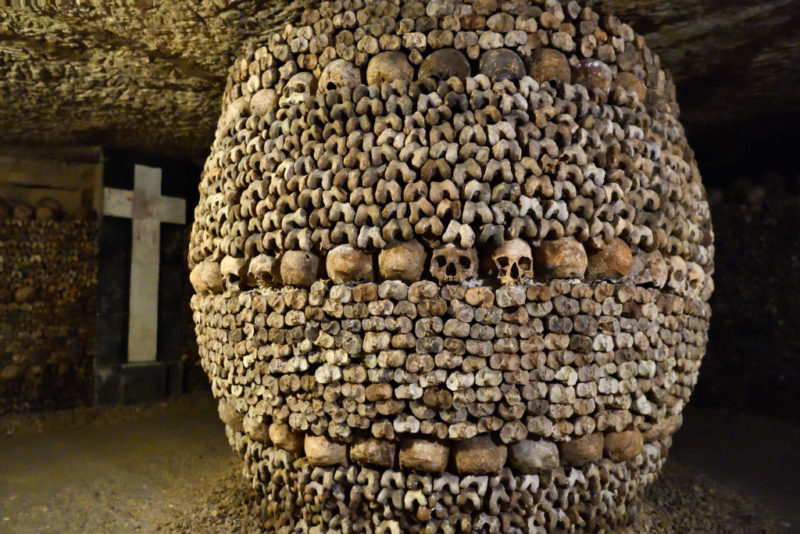 Skulls and leg bones put together to form a large underground column