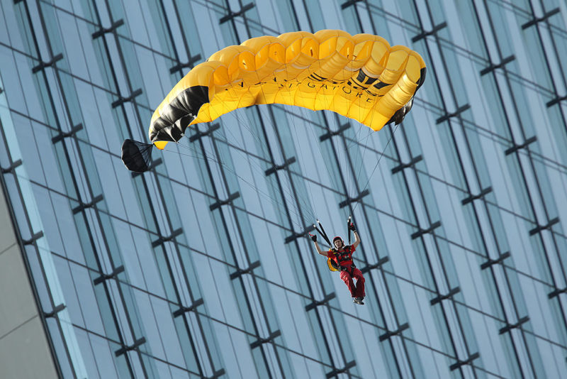 BASE jumper gliding through the air with a parachute