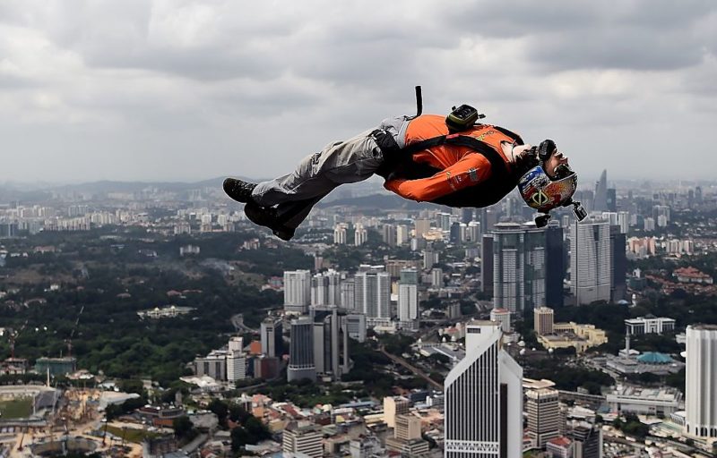 BASE jumper lying on his back while falling through the sky
