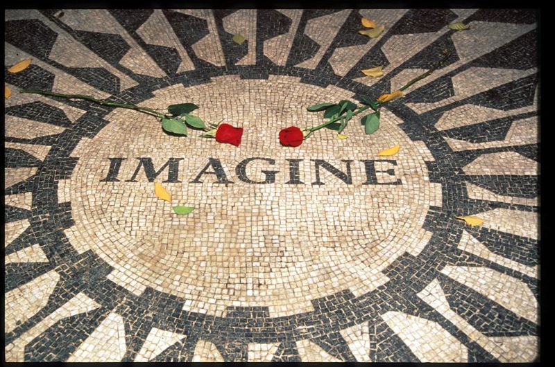 Two roses laid on top of the Imagine Mosaic 