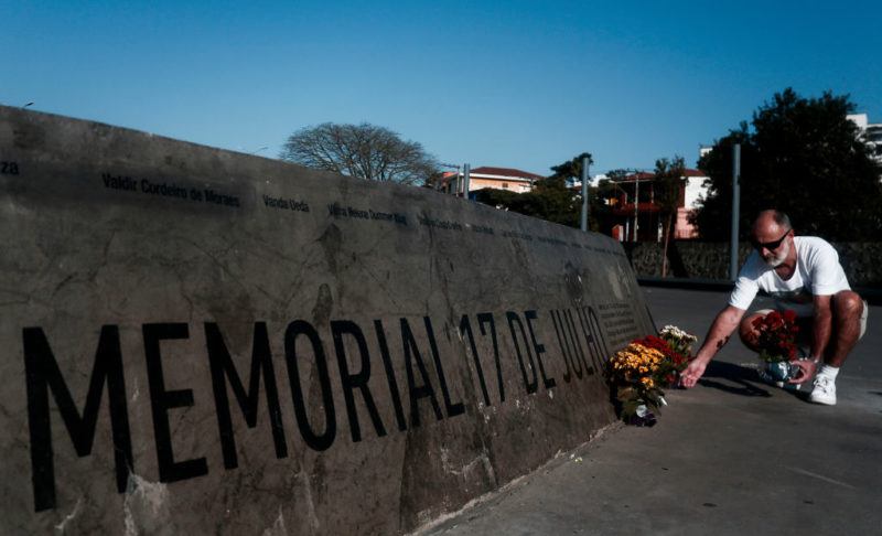 Man standing outside of the memorial dedicated to the victims of the TAM Airlines Flight 3054