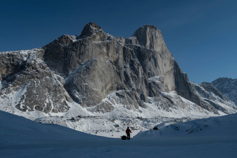 Man standing below Mount Thor