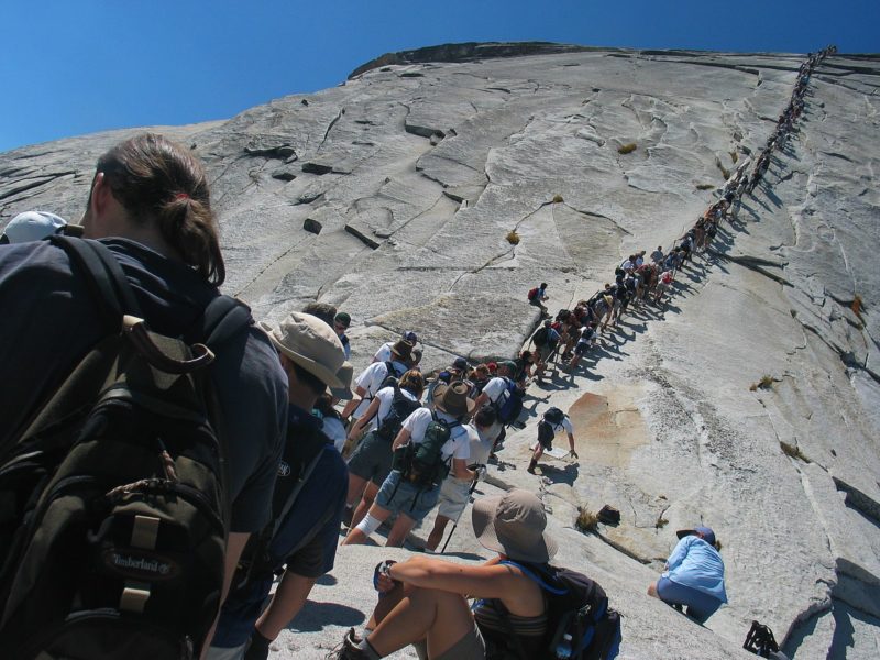 Hikers lining up to climb Half Dome Trail