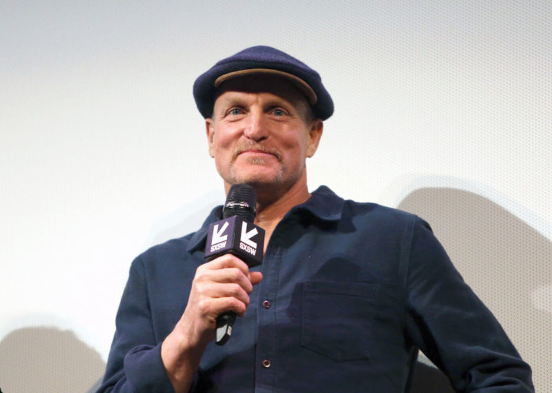 Woody Harrelson holding a microphone