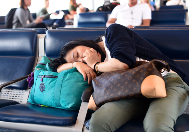 Woman sleeping in an airport terminal