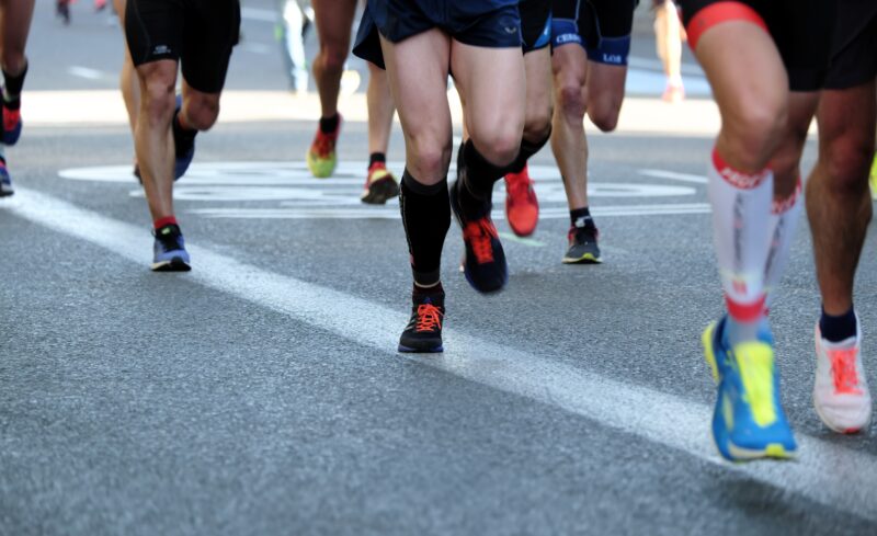 Marathoners running down a road