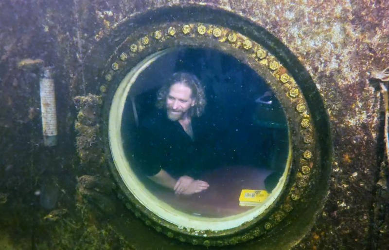 Joseph Dituri looking out the window of Jules' Undersea Lodge