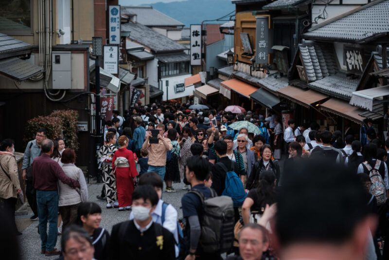 Crowds walking along a street in Kyoto