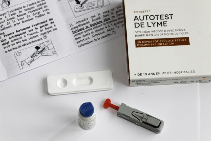 Components of a Lyme disease self-test spread out across a table