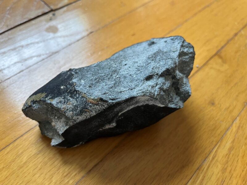 Chunk of meteorite on a hardwood floor