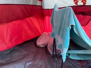 Towel and chair within a red tent