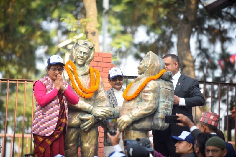 Nepalese government officials placing garlands over statues of Edmund Hillary and Tenzing Norgay